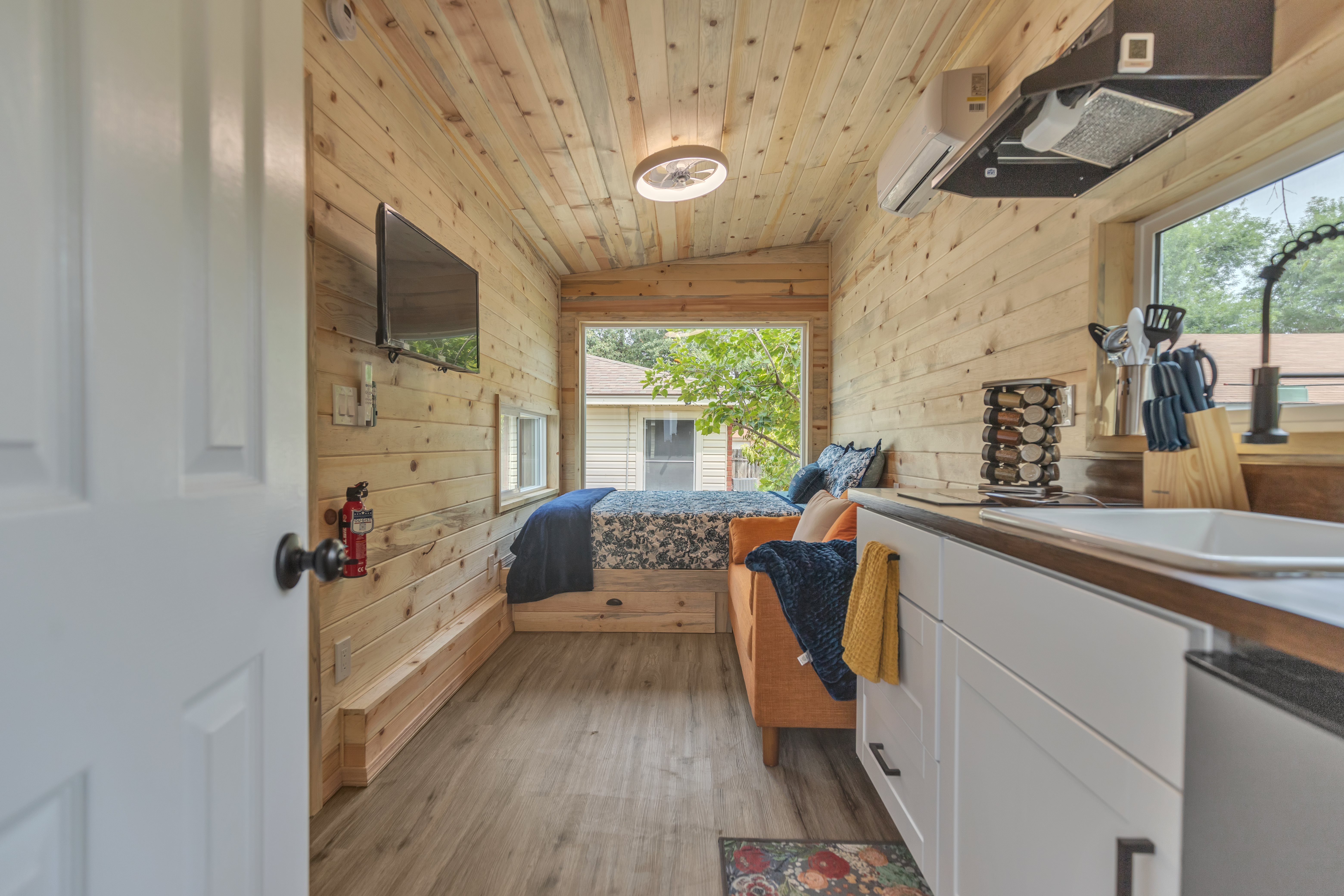 Cosy tiny home interior with kitchen and lounge